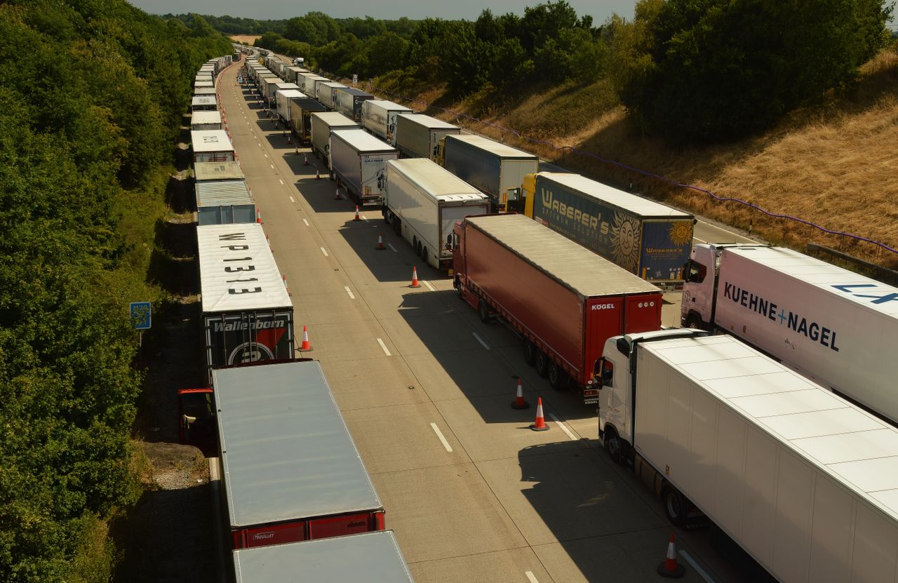 who-we-are-img Drone shot capturing traffic jam of trailer trucks on a highway in England.