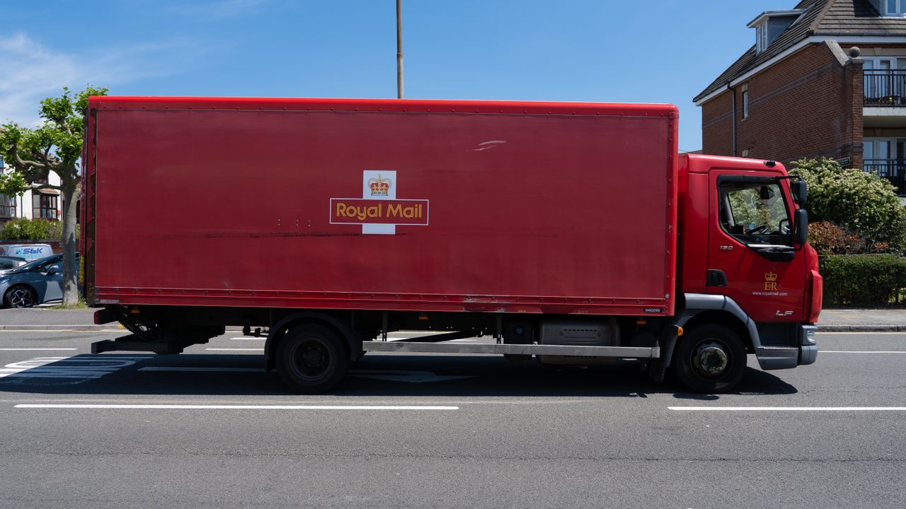 our-journey-03 A bright red Royal Mail truck parked on a sunny street in Portsmouth, UK.