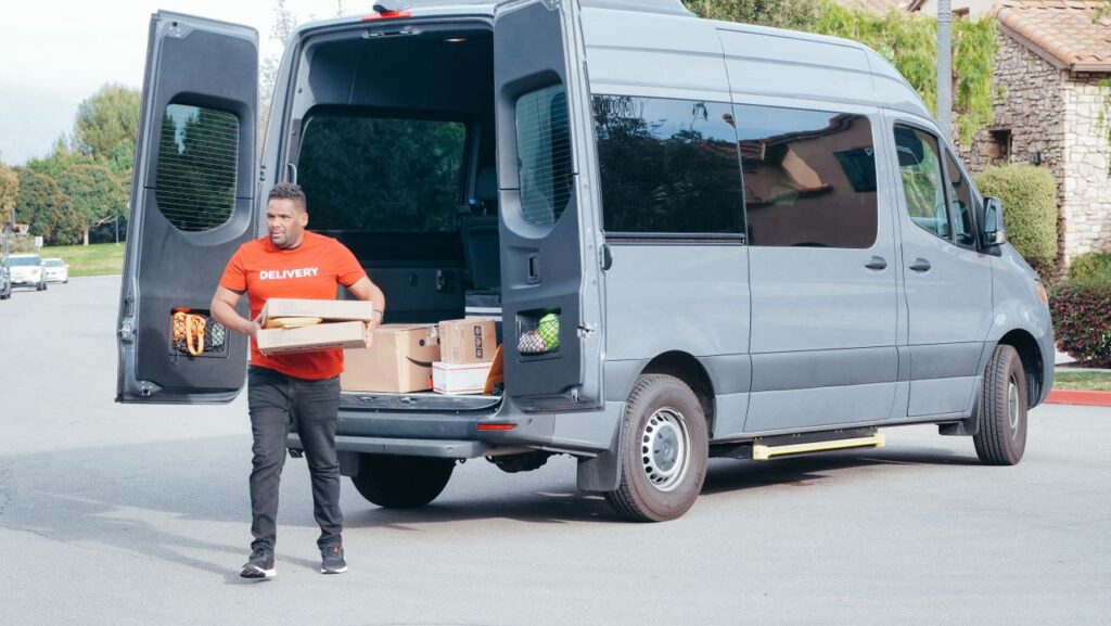 How Successful Entrepreneurs Maximize Productivity Courier in a delivery van distributing packages in a suburban setting.